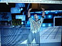 Referee Mike Chioda has just won a Steel Cage match for the WWE Championship that was between John Cena & Randy Orton.Note the partially obscured belt around his waist.